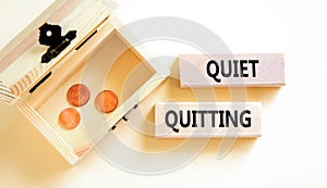 Quiet quitting symbol. Concept words Quiet quitting on wooden blocks. Beautiful white table white background. Wooden chest with