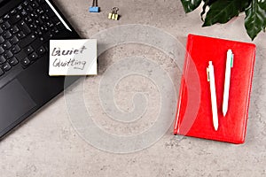 Quiet Quitting. Workplace desk with office supplies, potted plant, laptop computer with sticker and handwritten text