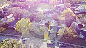 Quiet residential street and back alley of suburban neighborhood with blooming white flower of Bradford pear or Pyrus calleryana,