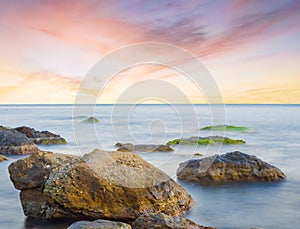 Quiet stony sea coast at the dramatic sunset