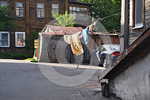 Quiet Vladimirsky courtyard in the evening rays of the setting summer sun. Provincial life of Russia.