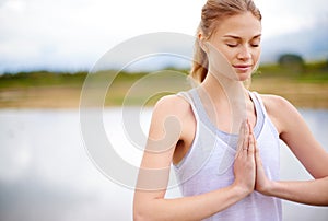 The quieter you become, the more you can hear. a sporty young woman holding her hands in prayer position.