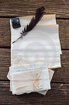 Quill feather, ink bottle, and legal documents arranged on table