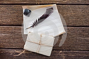 Quill feather, ink pot, and legal documents arranged on table