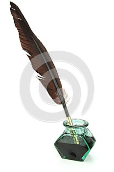 Quill pen in glass ink bottle