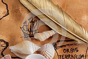 Quill pen on sea map with illustrations of sailing vessels on the order of antiquities on birchbark photo