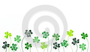 Quilling clover leaves for St. Patrick`s Day banner. Green shamrock leaves made from rolled paper isolated on white background.