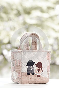 Quilt bag handmade craft on garden background