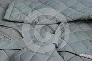 Quilted long jacket. Lying on the table. Close-up