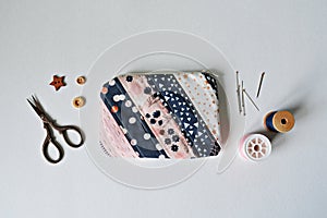 Quilted patchwork notion pouch, thread, metal pins, scissors and wooden buttons