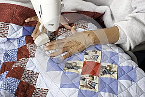 A quilter machine quilting patriotic quilt.