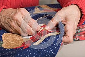 Quilter stitching quilt