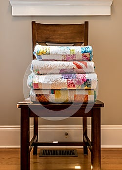 Quilts Stacked on Wooden Chair