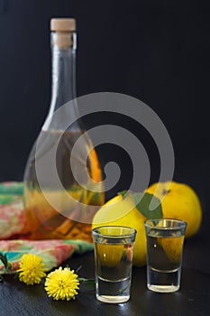 Quince brandy, strong drink in a bottle and glasses