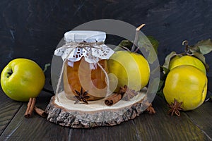 Quince jam in glass jar and fresh quince