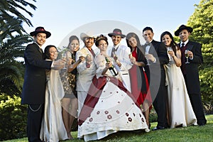 Quinceanera Standing With Family And Friends