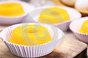 Quindim or Brisa do Lis, tasty dessert made with eggs in the background, Typical recipe from Brazil and Portugal photo