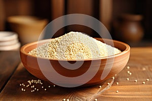 Quinoa in bowl on wooden kitchen table