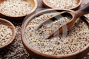 Quinoa in bowl on wooden kitchen table. Healthy and diet superfood product