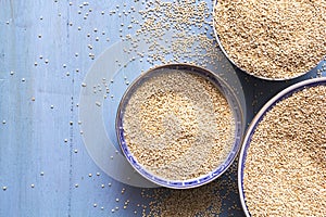 Quinoa in bowls on blue wooden table