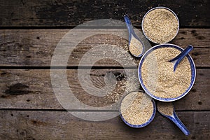 Quinoa in bowls on wooden table