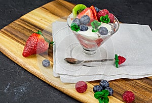 Quinoa chia seeds dessert strawberry blueberry raspberry fresh mint on black background