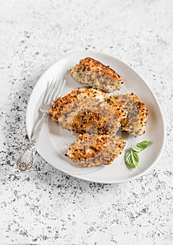 Quinoa crusted chicken on a light background.