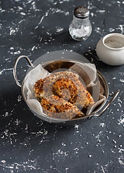 Quinoa crusted chicken in a metal bowl.