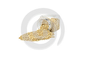 quinoa falling out of a glass jar isolated on white background.