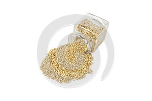 quinoa falling out of a glass jar isolated on white background.