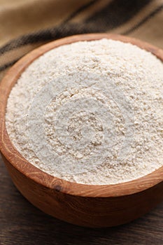 Quinoa flour in bowl on table, closeup