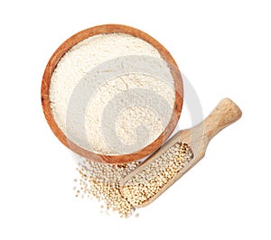 Quinoa flour in wooden bowl and scoop with seeds on white background, top view