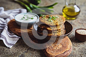 Quinoa fritters with zucchini, garlic and green onion served with yoghurt dip