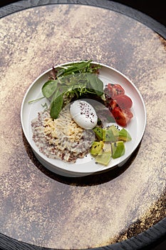 Quinoa porridge breakfast with oatmeal, poached egg
