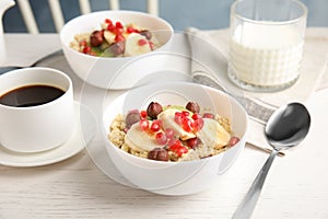 Quinoa porridge with hazelnuts, kiwi, banana and pomegranate seeds served for breakfast