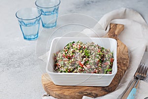 Quinoa Quinua salad with tomatoes and herbs in white bowl photo