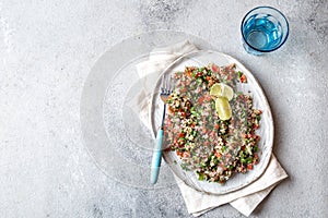 Quinoa Quinua salad with tomatoes and herbs in white bowl