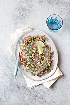 Quinoa Quinua salad with tomatoes and herbs in white bowl