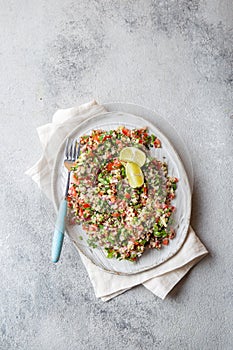 Quinoa Quinua salad with tomatoes and herbs in white bowl photo