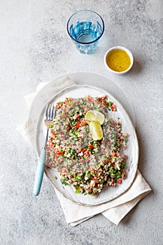 Quinoa Quinua salad with tomatoes and herbs in white bowl