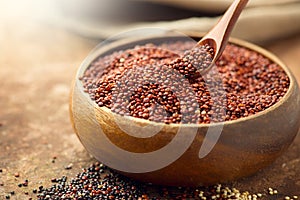 Quinoa. Red, black and white quinoa grains in a wooden bowl. Healthy food. Chenopodium quinoa