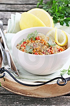 Quinoa salad with vegetables, herbs and lemon.