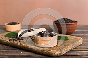 quinoa seeds in bowl and spoon on colored background. Healthy kinwa in small bowl. Healthy superfood