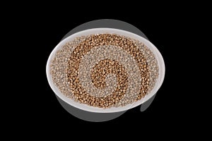quinoa seeds in a in small white, oval ceramic bowl