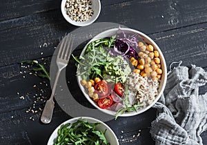 Quinoa and spicy chickpea vegetable vegetarian buddha bowl. Healthy food concept. On a dark background photo