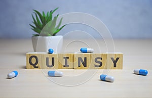 Quinsy word on wooden cubes. quinsy concept. medical concept photo
