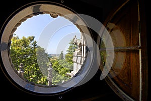 Quinta da Regaleira - view of the garden through a round window of the castle. photo