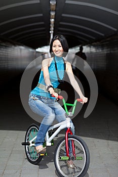 Quirky, funky chinese woman on street bike