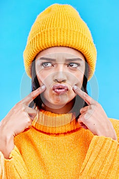 Quirky, goofy and young female in a studio with a comic, funny and crazy face expression. Gen z, silly and beautiful