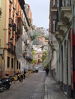 Quitet street in Granada, lined with orange coloured houses